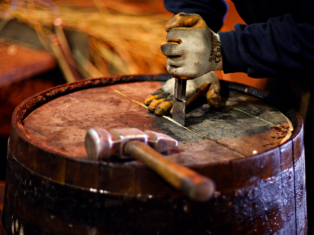 Cooper working on a cask with tools
