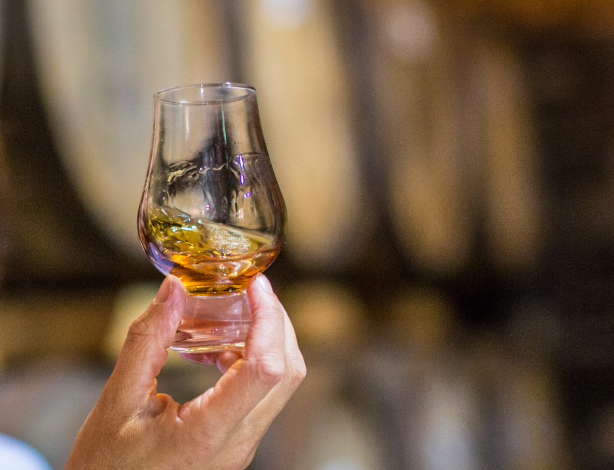 A dram of Scotch Whisky held in a hand